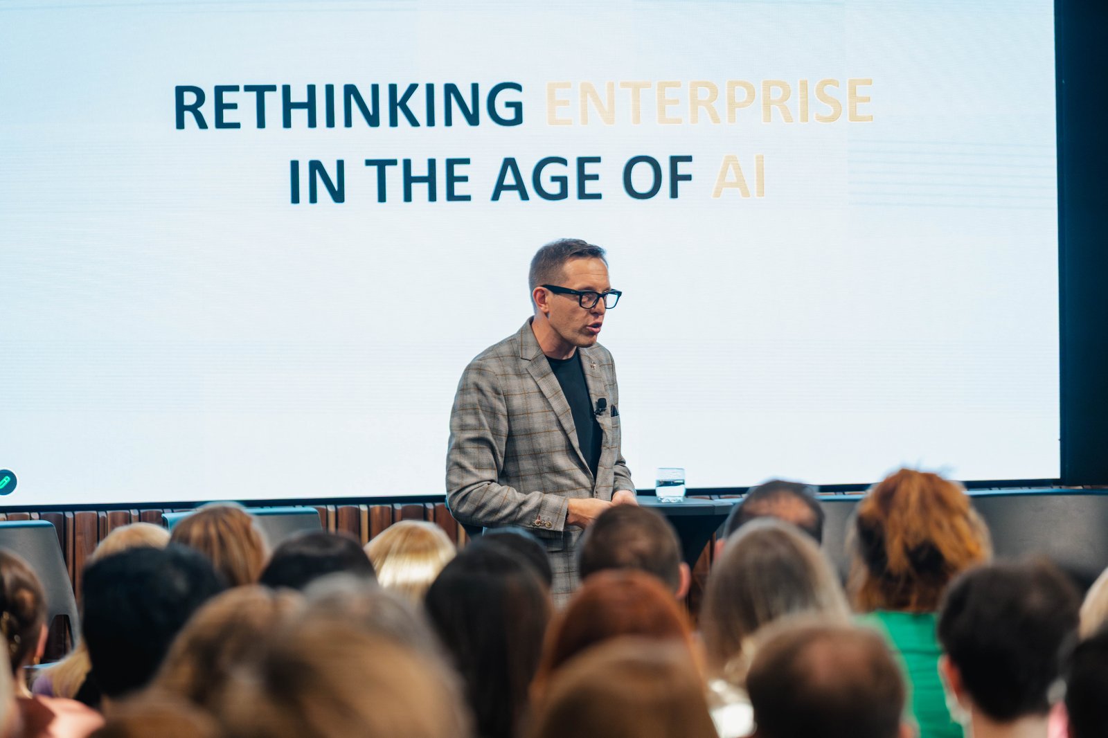 Marek Kowalkiewicz presenting 'Rethinking enterprise in the age of AI' to a full auditorium